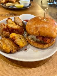 The People's Kitchen signature dishes TPK BurgerFried Chicken SandwichBrussels Sprouts AppetizerSeasonal Gnocchi